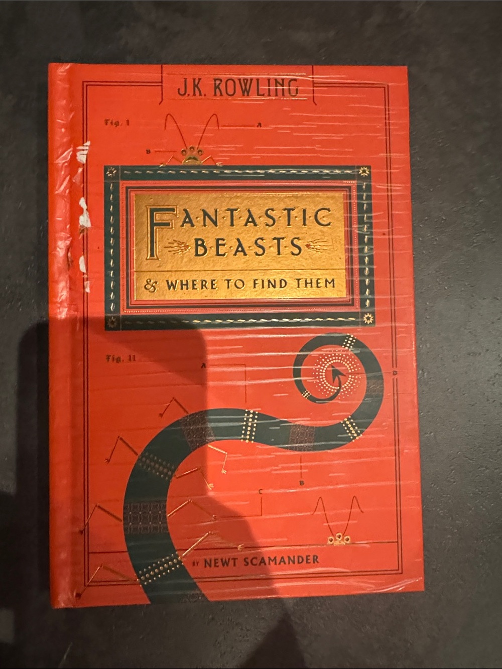 Fantastic Beasts & Where to Find Them by J.K. Rowling - Red hard copy book